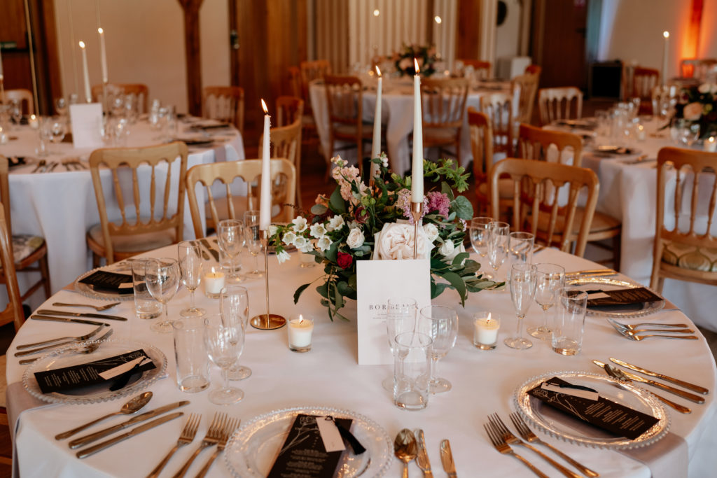 A round table arrangement in the knot barn, which is included in both packages